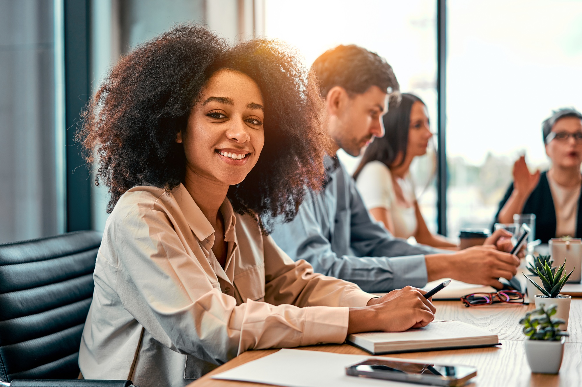 Portrait of african american business lady turning to camera while visiting business conference with